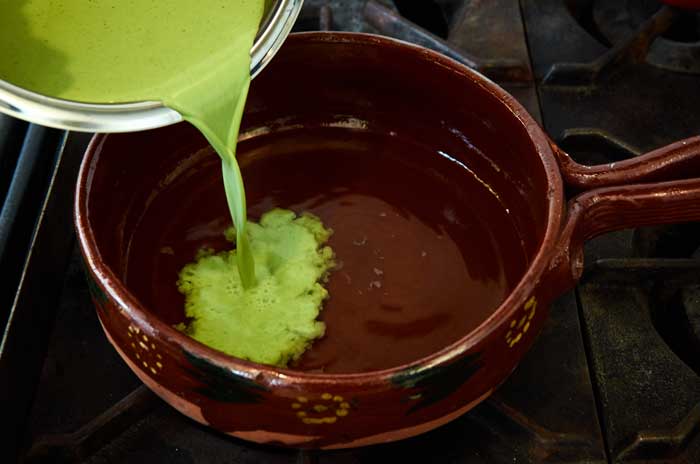pouring-cilantro-soup-base-into-chicken-broth