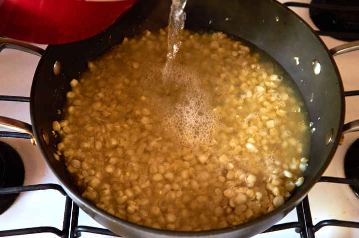 Adding Water to Corn Kernels in Pan