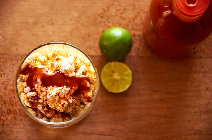 Cup of Mexican Street Corn with Hot Sauce and Lime