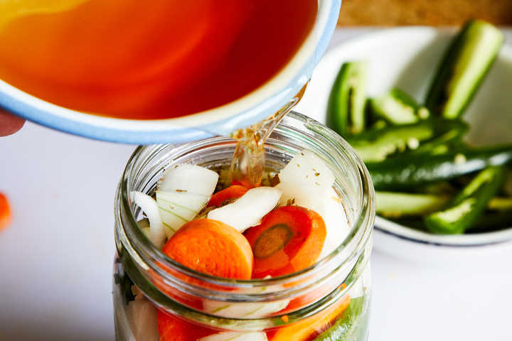Adding Vinegar to Jar of Mexican Pickled Peppers (Chiles en Vinagre)
