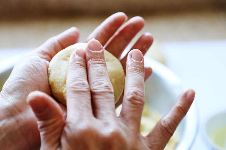 Hand forming potato croquettes.