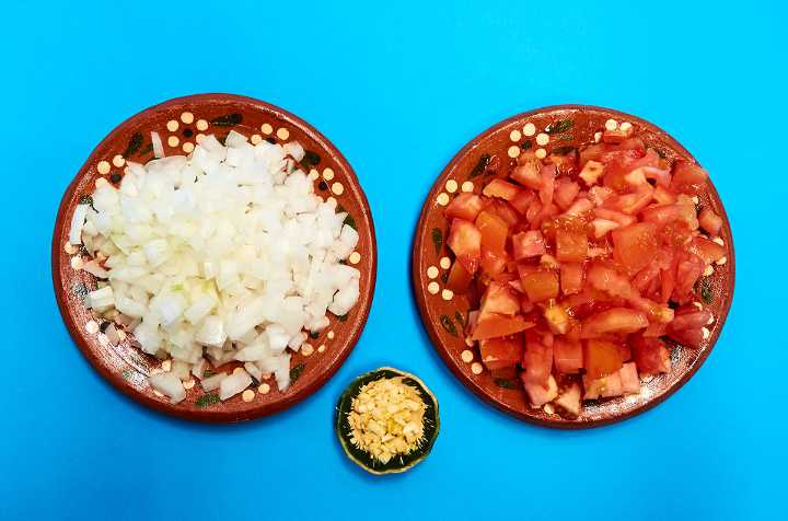 Plates of Chopped Onion Tomato Garlic