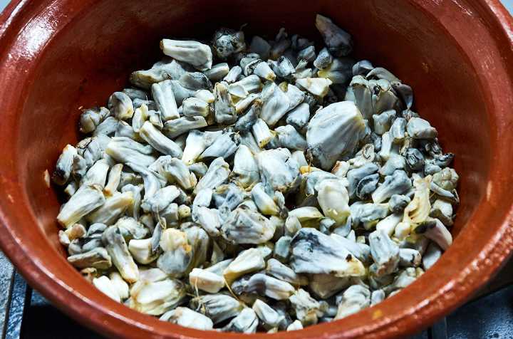 Huitlacoche in clay pot on stove.