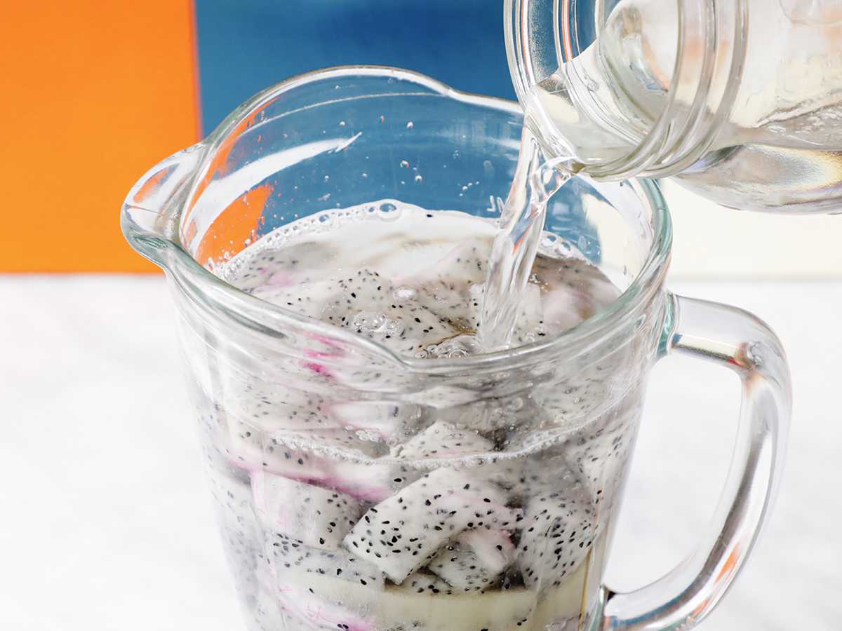 Adding water to blender jar.